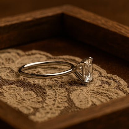 Elegant Gold Moissanite Ring With Cushion Cut Stone Reflecting Diamond Sparkle, Perfect For Weddings And Engagements.