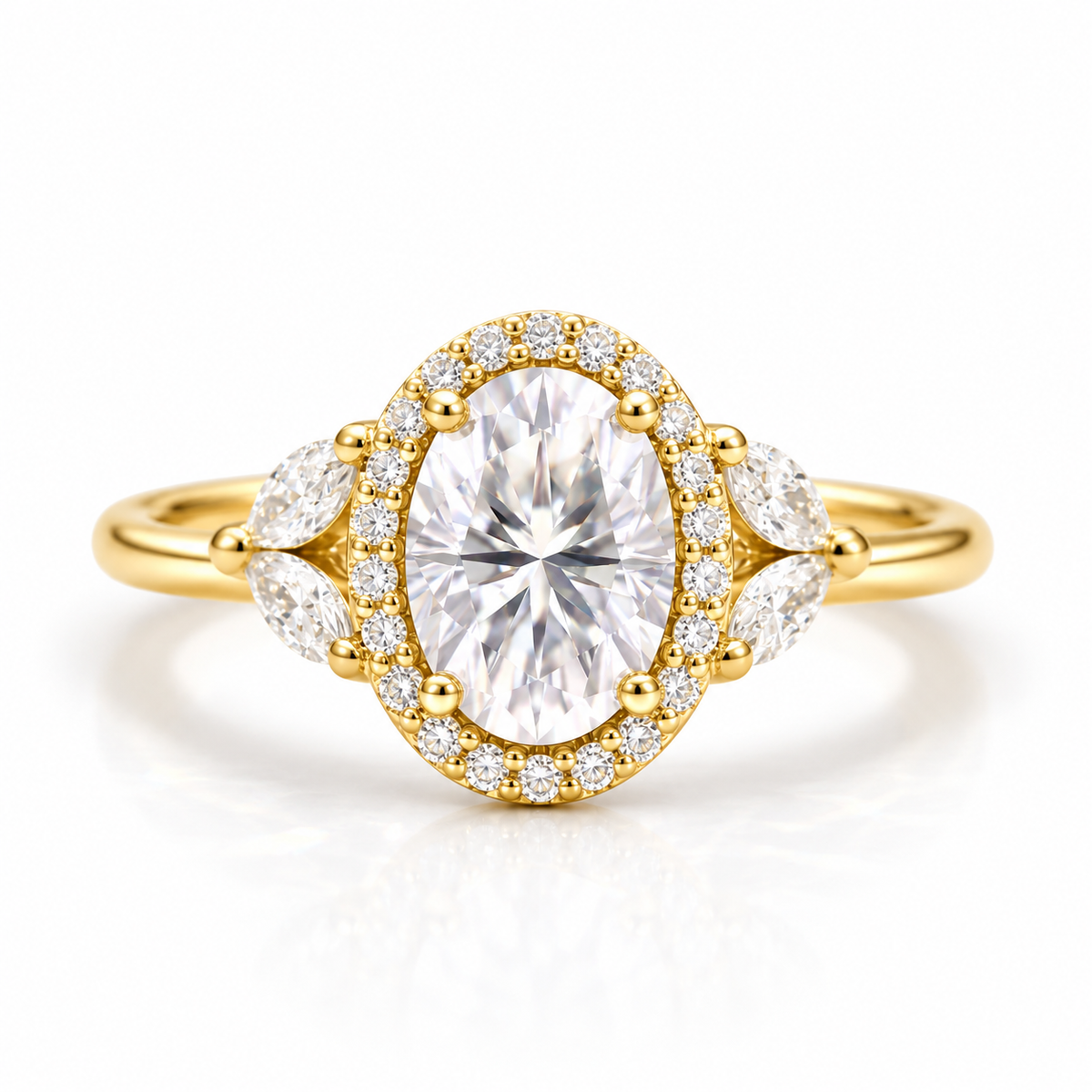 Gold oval engagement ring with a sparkling diamond halo, pear-shaped side stones, pavé accents, and polished gold band.
