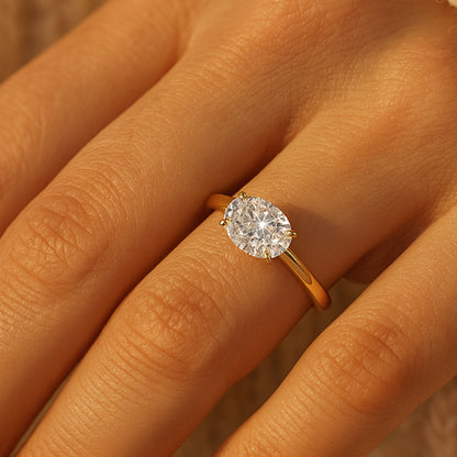 Gold Oval Diamond Engagement Ring, A Classic Solitaire Style That Captures Light Beautifully And Symbolizes Timeless Love.