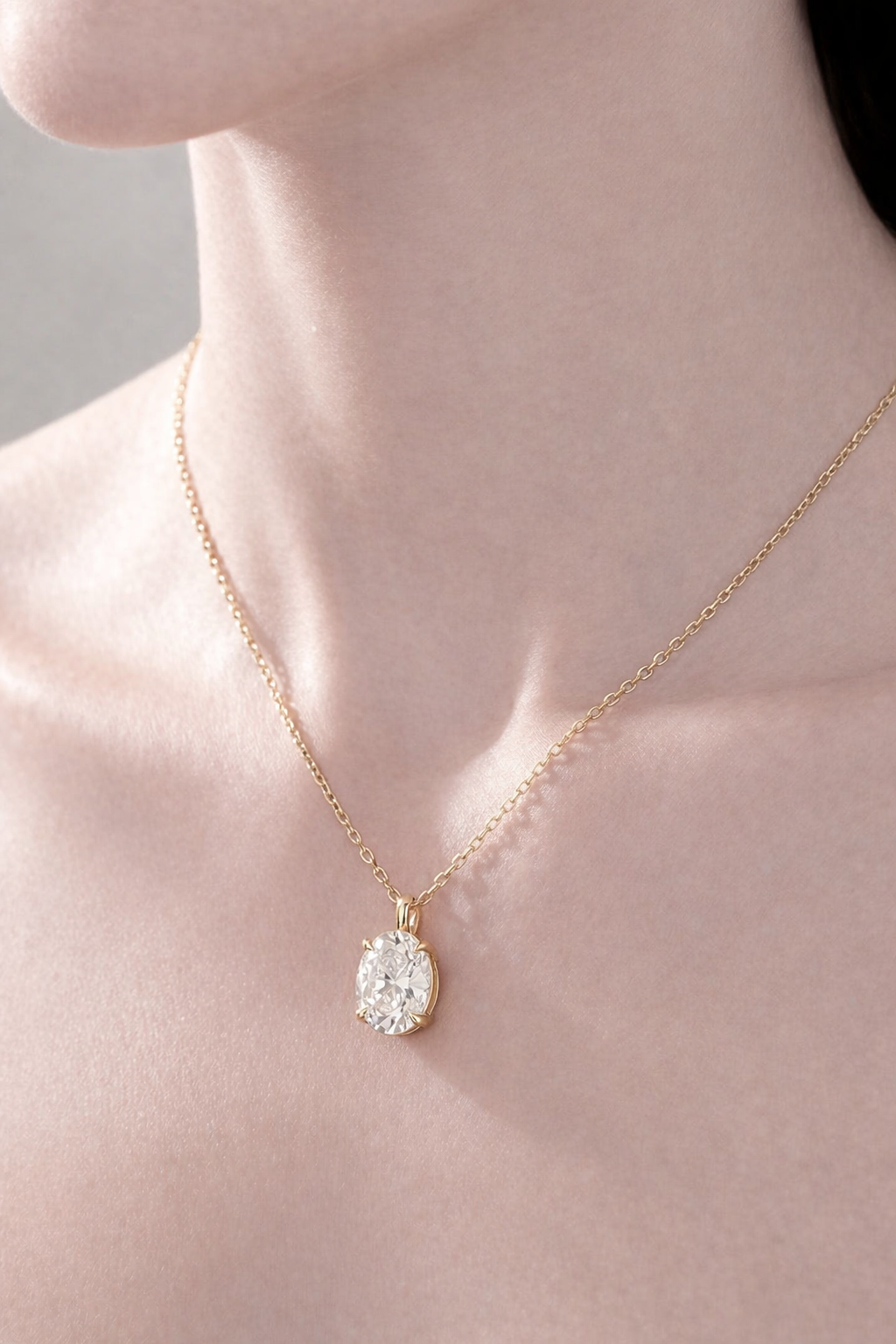 Oval Moissanite Pendant In Gold With 4-Prong Setting For A Delicate Look.
