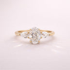 Oval Three Stone Engagement Ring With Pear Cut Side Stones In Yellow Gold
