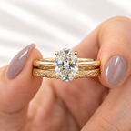Oval cut colorless ring stone with crisp brilliant facets reflecting bright white and rainbow light
