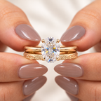 Close up of an oval cut colorless ring stone with brilliant faceting and four claw prongs