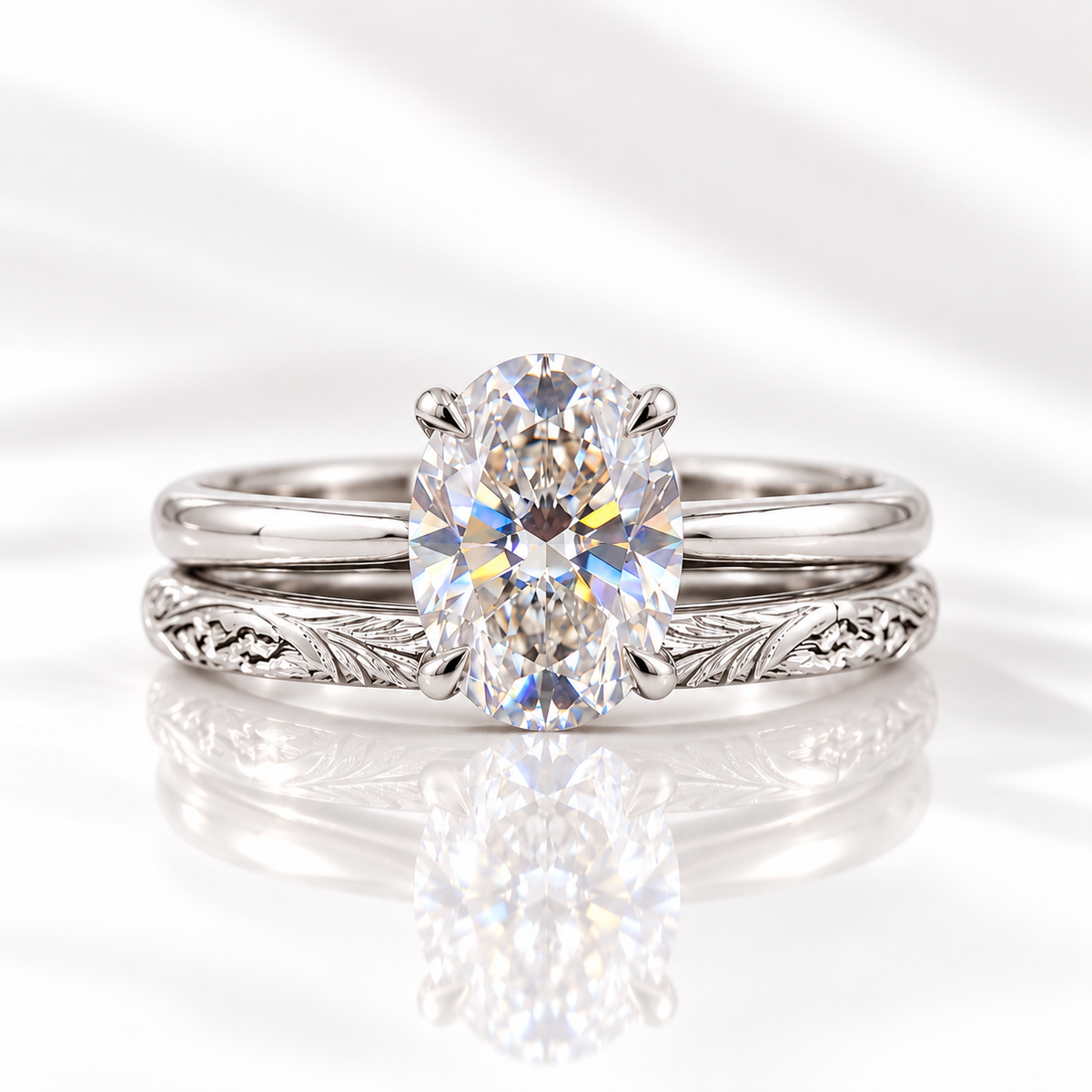 Oval cut colorless ring stone with brilliant facets and bright rainbow flashes, held by four prongs