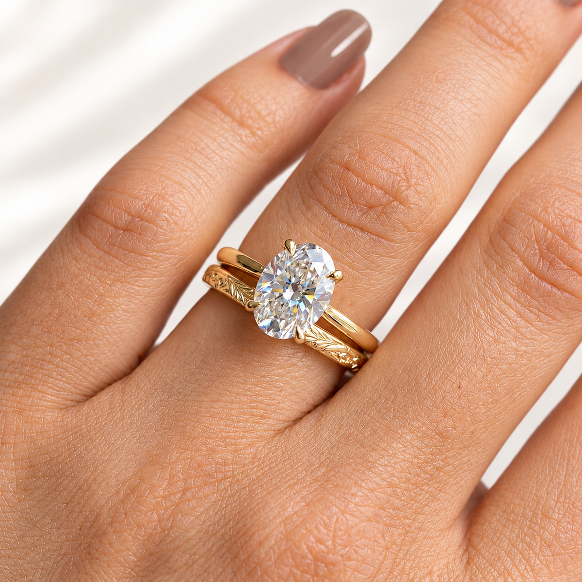Oval cut colorless ring stone with elongated shape and bright faceted sparkle in a four-prong setting
