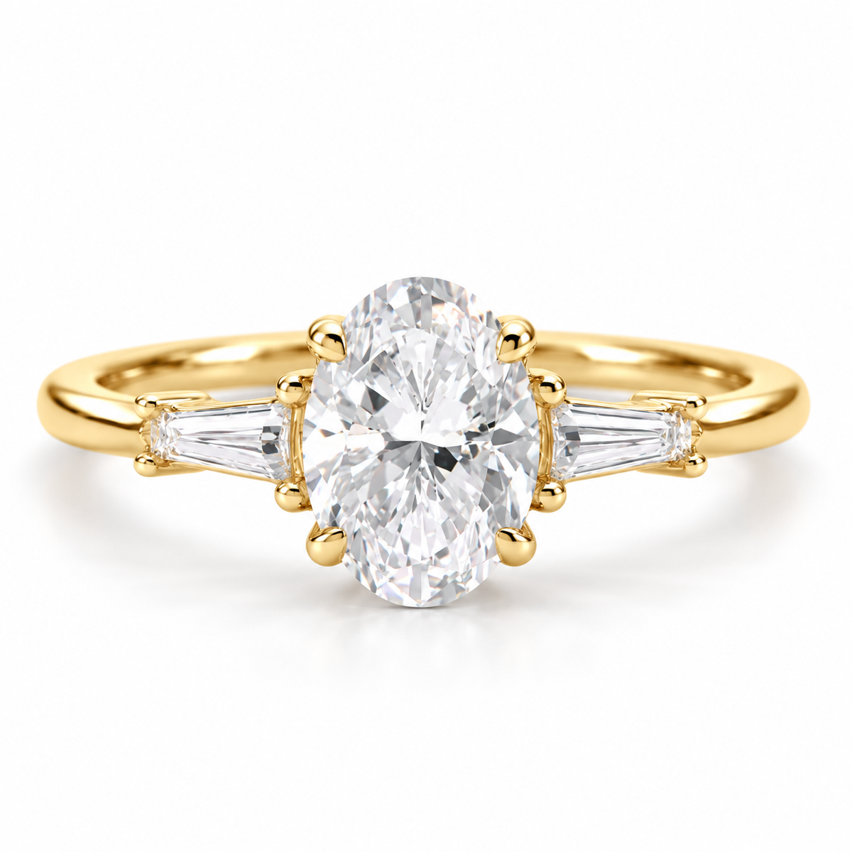 Oval cut diamond engagement ring in polished yellow gold with tapered baguette side diamonds and a six-prong setting.