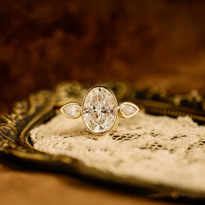 Elegant Bezel Set Oval Moissanite Engagement Ring With Pear Accents And Brilliant Diamond Alternative Shine
