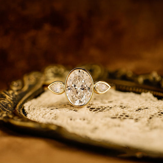 Elegant Bezel Set Oval Moissanite Engagement Ring With Pear Accents And Brilliant Diamond Alternative Shine
