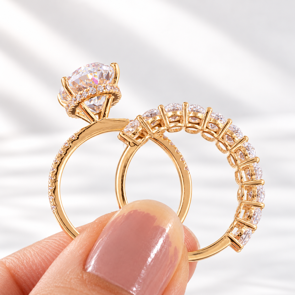 Oval cut colorless ring stone with brilliant facets, four prongs, and a hidden halo of small round stones beneath