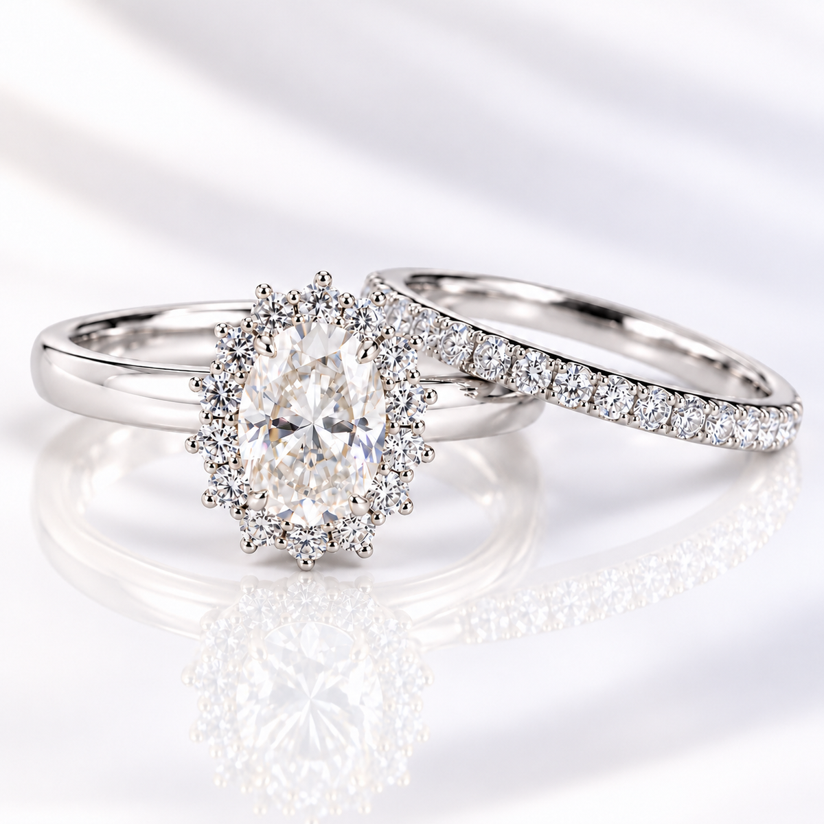 Oval cut clear ring stone with sharp brilliant facets, framed by a halo of tiny round accent stones