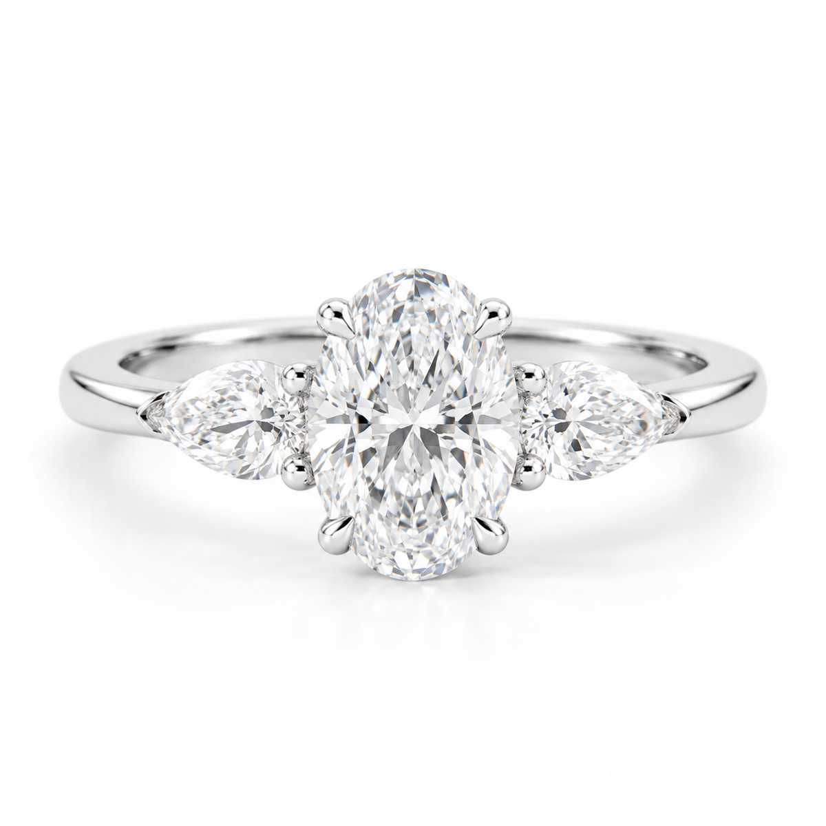Oval cut diamond three-stone engagement ring in polished silver with two pear-shaped side diamonds and a sleek polished band.