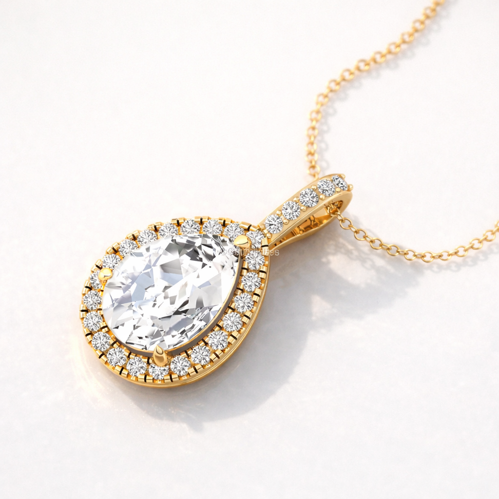 Yellow Gold Pendant With A Pear-Shaped Diamond And Round Halo Setting.
