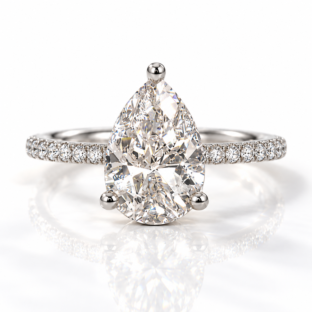 Pear cut diamond center stone in a three-prong rose gold setting with a pavé diamond band