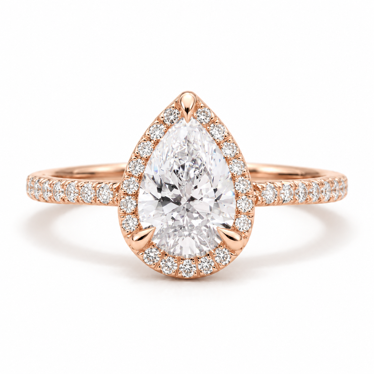 18K rose gold pear shaped halo engagement ring with a sparkling pear cut center stone and pavé diamond halo on a diamond accented band