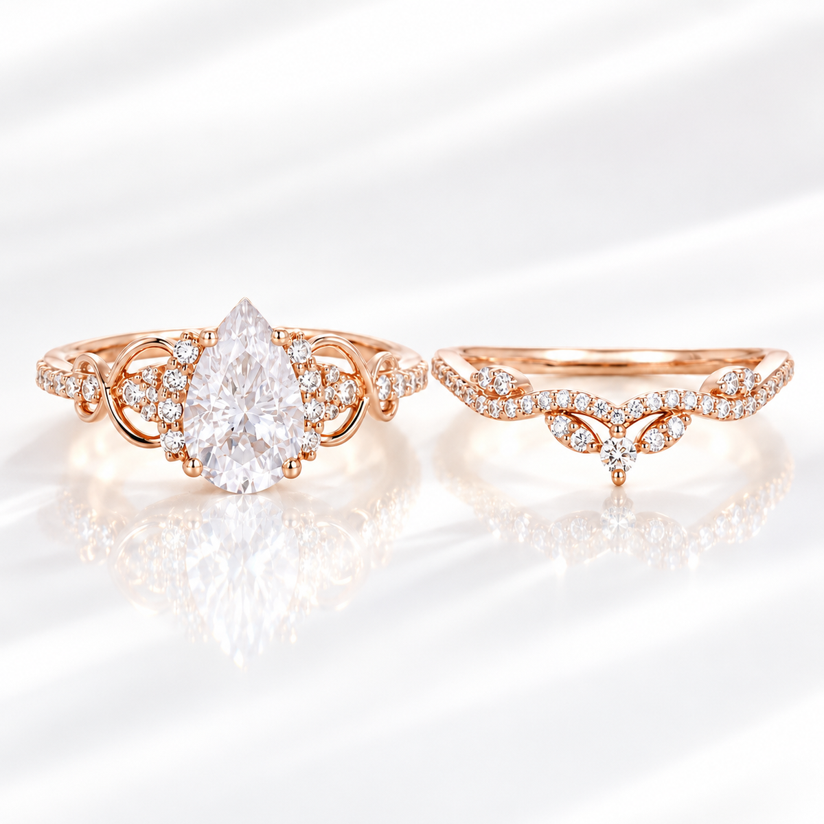 Pear cut colorless ring stone with a clear table and symmetrical teardrop shape, with small accent stones on both sides