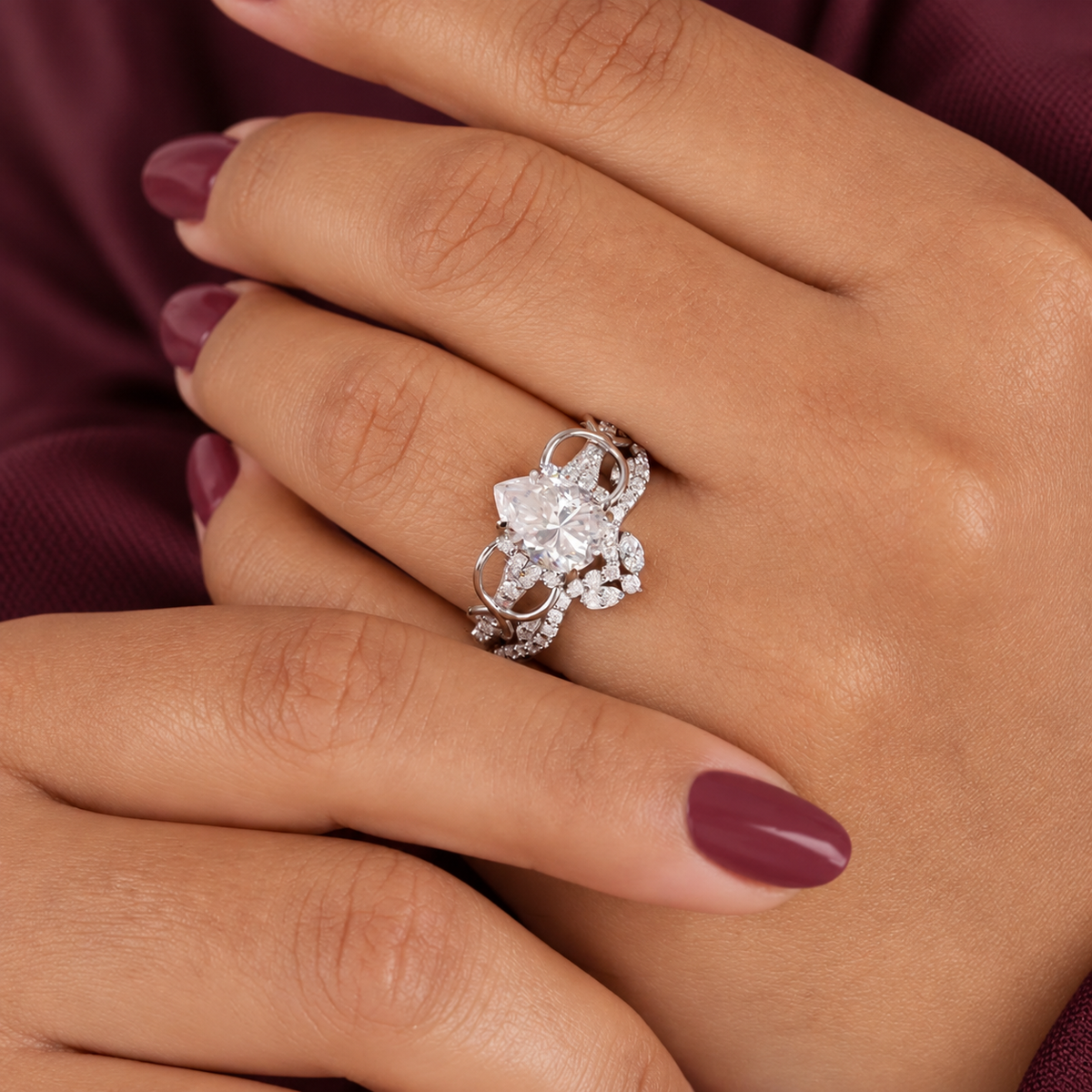 Pear cut colorless ring stone with soft white sparkle and clear brilliant facets, framed by small accent stones