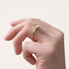 Gold Three Stone Round Diamond Ring With A Polished Metal Band.
