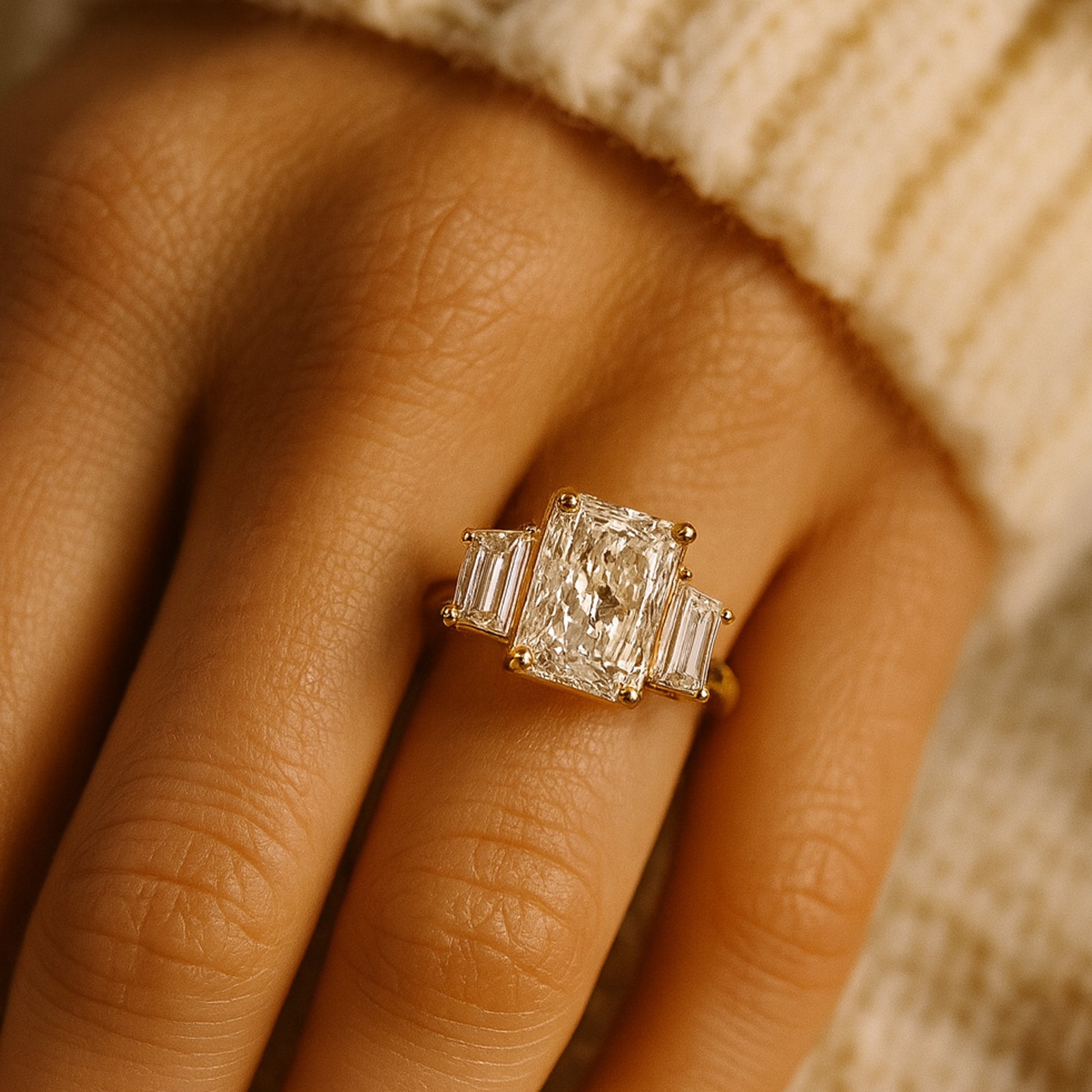 Radiant Cut Three Stone Diamond Engagement Ring With Emerald Side Stones In 18K Yellow Gold Setting