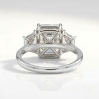 Underside view of a three-stone radiant cut diamond engagement ring, highlighting the open gallery wire trellis basket setting and polished white gold band.