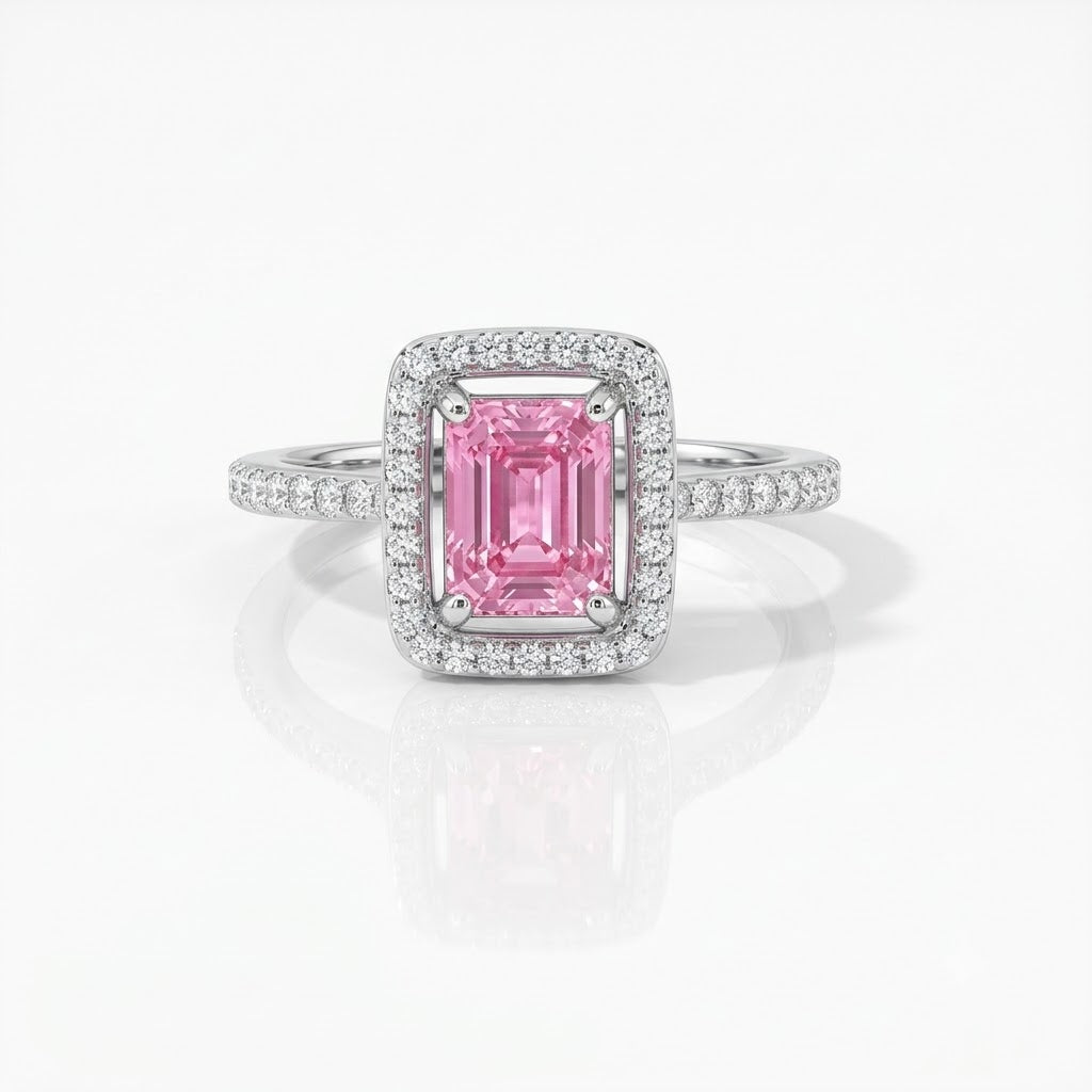 A square-cut pink gemstone ring with a halo setting and a pavé band, shown on a clean white background with a soft reflection.