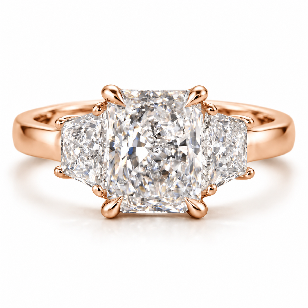 Three stone radiant cut diamond engagement ring with a large center diamond, side diamonds, and polished 18K rose gold vermeil band in an elegant luxury setting.