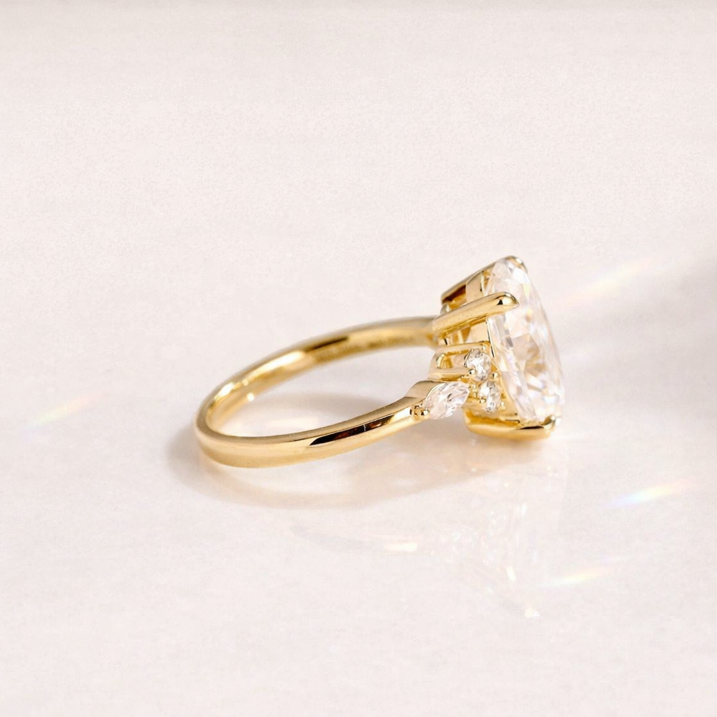 Classic Oval Engagement Ring With Marquise And Round Side Stones
