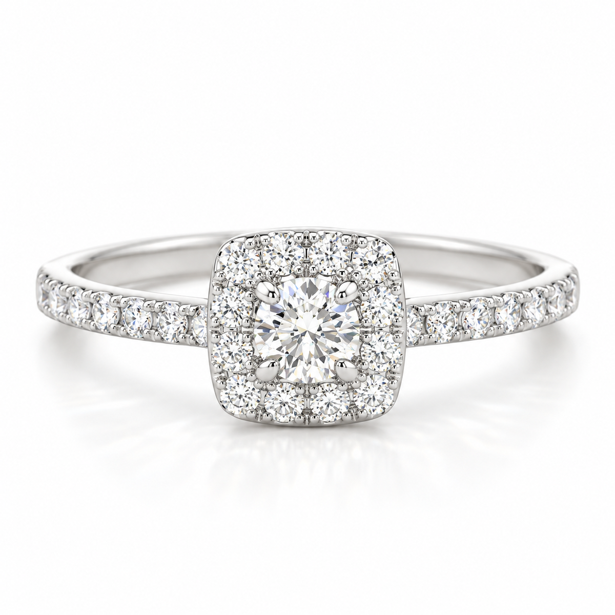 Cushion halo round brilliant cut diamond engagement ring in polished silver with pavé diamond band and four-prong center setting.