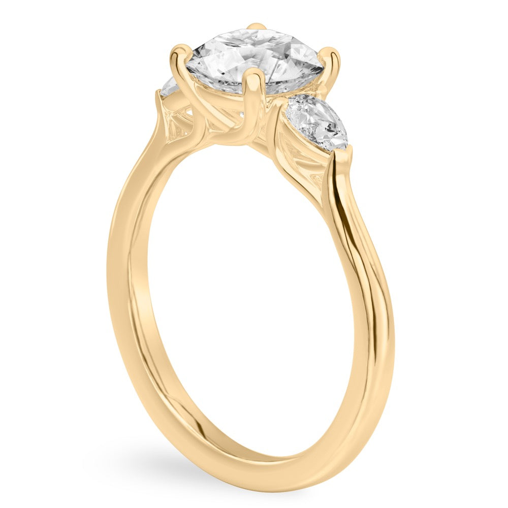 Trellis Ring Featuring 2 Pear Cut Side Stone Accents In Gold.
