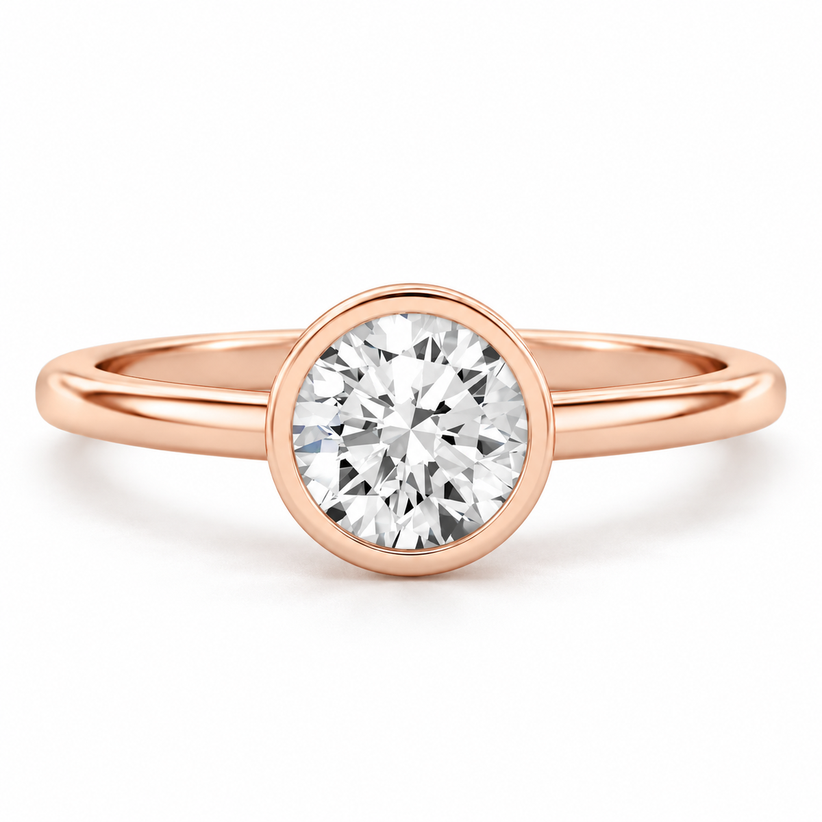 Round brilliant cut diamond solitaire ring in 18K rose gold vermeil with a polished circular bezel setting and smooth rounded band.
