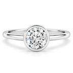 Round brilliant cut diamond solitaire ring in polished silver with a sleek circular bezel setting and smooth rounded band.