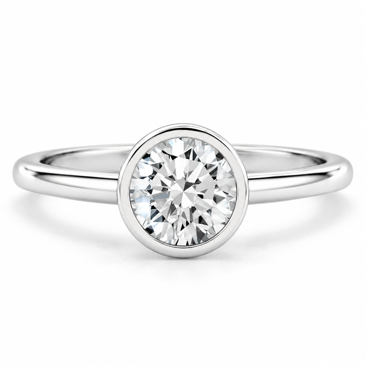 Round brilliant cut diamond solitaire ring in polished silver with a sleek circular bezel setting and smooth rounded band.
