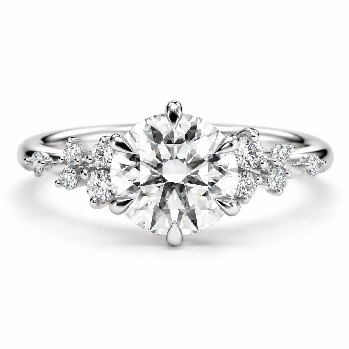 Polished silver solitaire engagement ring featuring a large round brilliant cut diamond with elegant six-prong setting, delicate floral diamond cluster accents on both sides, and a sleek silver band with a luxurious fine jewelry design.