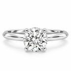 Round brilliant cut solitaire diamond ring in polished silver with a smooth band and four-prong setting.