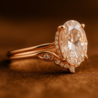 Romantic Oval Moissanite Ring With Curved Band And Accent Stones On Soft Fabric Background