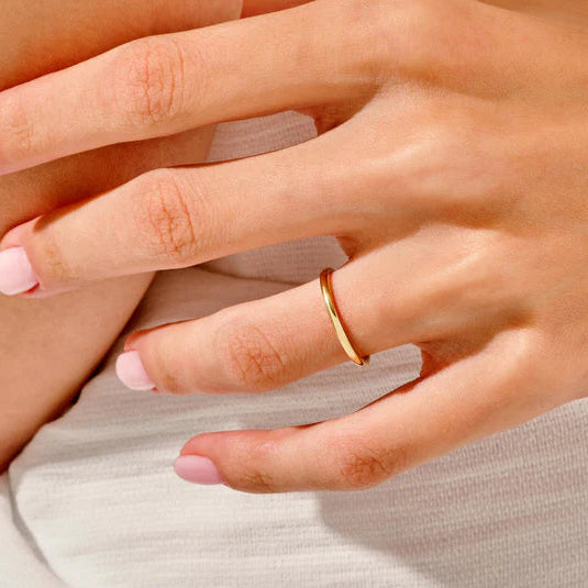 Simple wedding band paired with solitaire diamond ring
