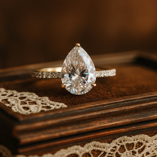 Gold Pear Diamond Ring By Diiro Worn On Hand, Highlighting The Elegant Teardrop-Cut Diamond And Refined Pavé Band Design.
