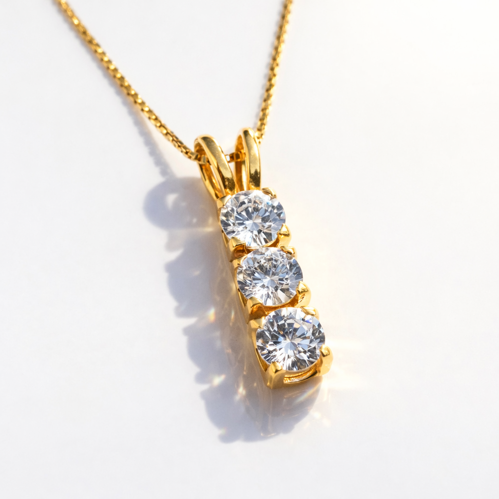 Three-Stone Diamond Pendant In Yellow Gold With A Vertical Bar Design.
