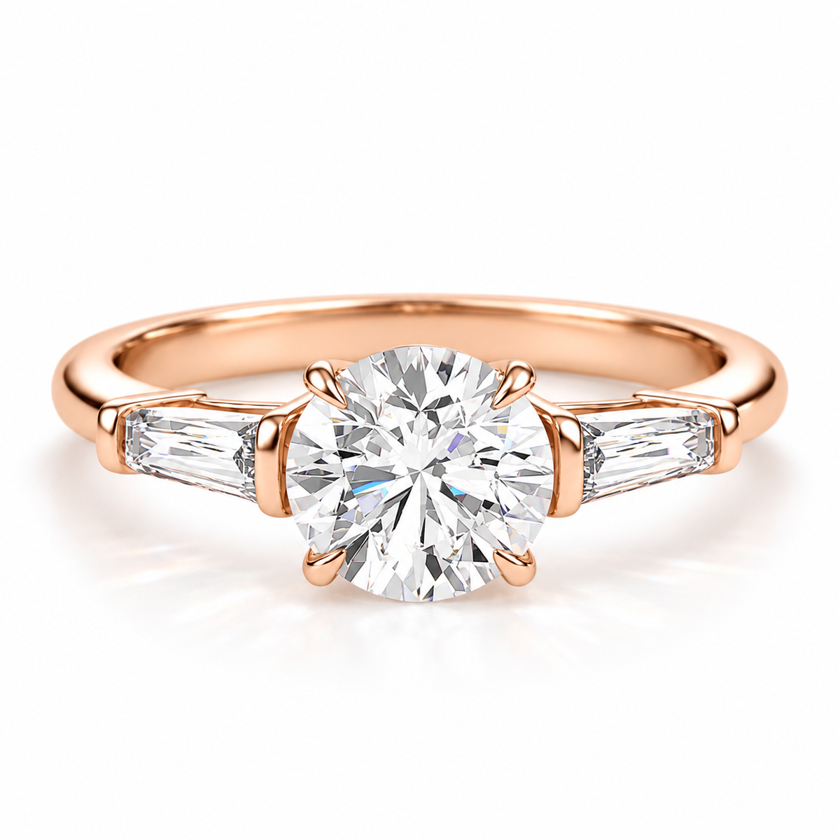 Round brilliant cut diamond engagement ring in 18K rose gold vermeil with tapered baguette side diamonds and a four-prong setting.