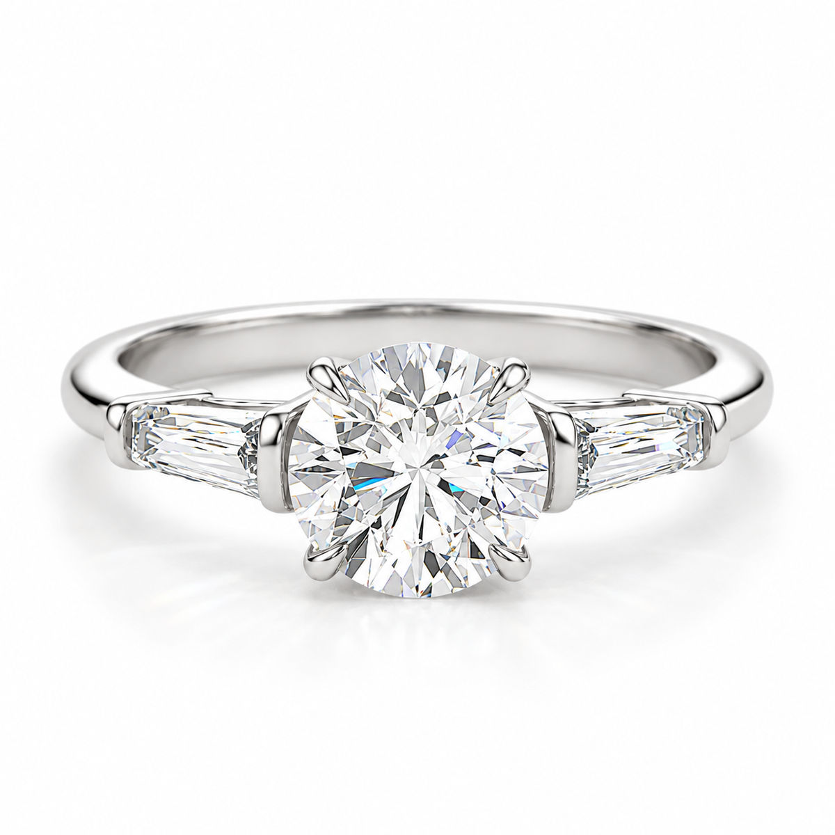Round brilliant cut diamond engagement ring in polished silver with tapered baguette side diamonds and a four-prong setting.