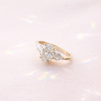 Moissanite Engagement Ring With Oval Center And Two Pear Cut Side Stones
