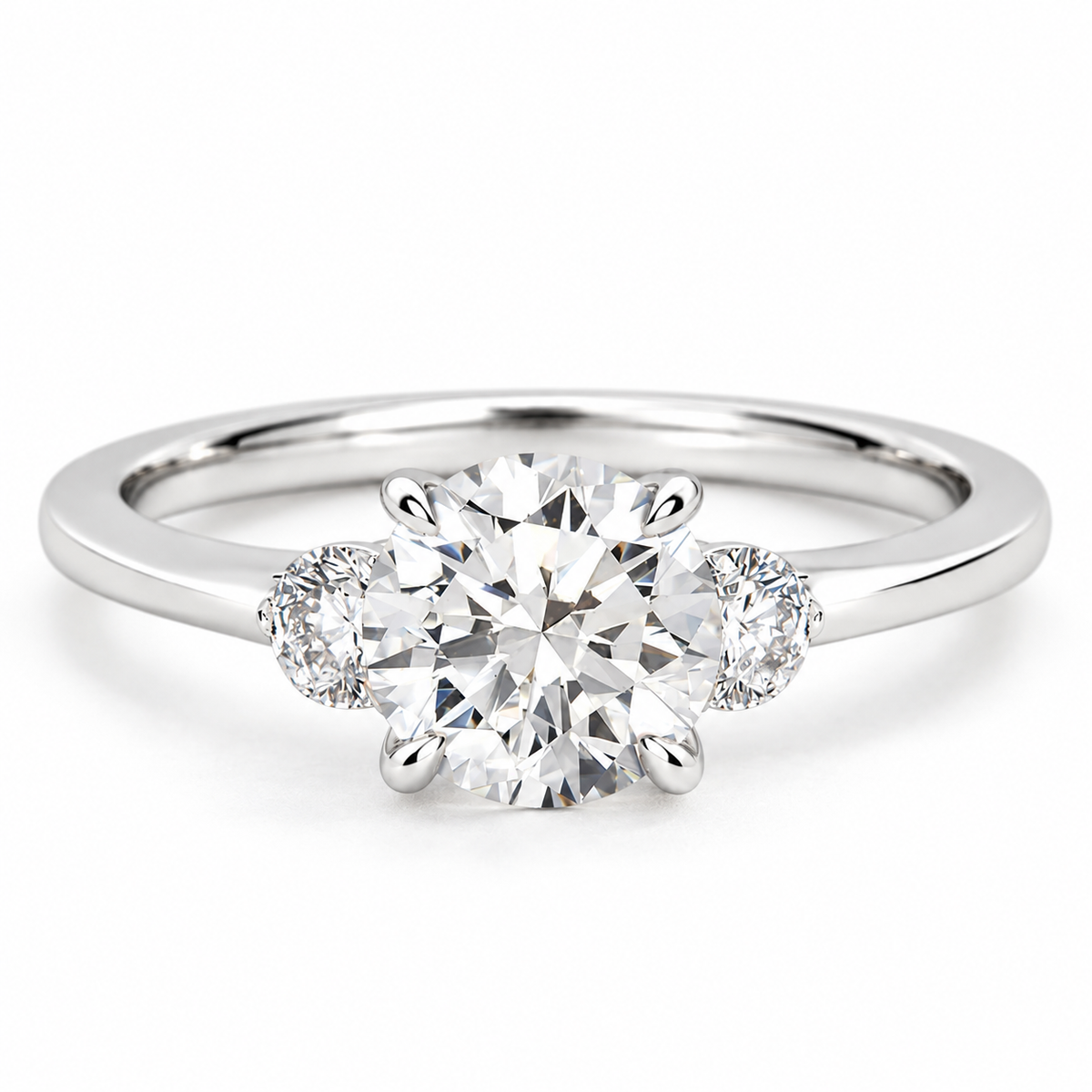 Three-stone round brilliant cut diamond engagement ring in polished silver, featuring a large center diamond with two smaller side diamonds in a classic three-stone setting on a sleek band