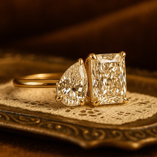 Elegant Radiant And Pear Cut Moissanite Toi Et Moi Ring Featuring Brilliant Diamond Alternative Stones In Gold Setting.