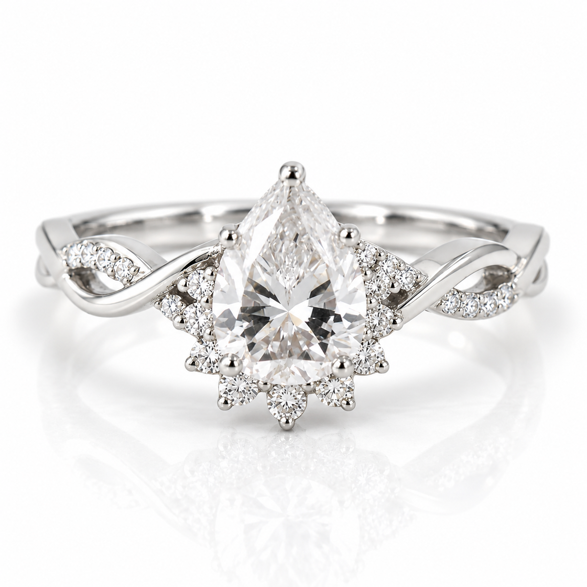 Polished silver pear-shaped engagement ring with sparkling halo, pavé diamond accents, and twisted band design