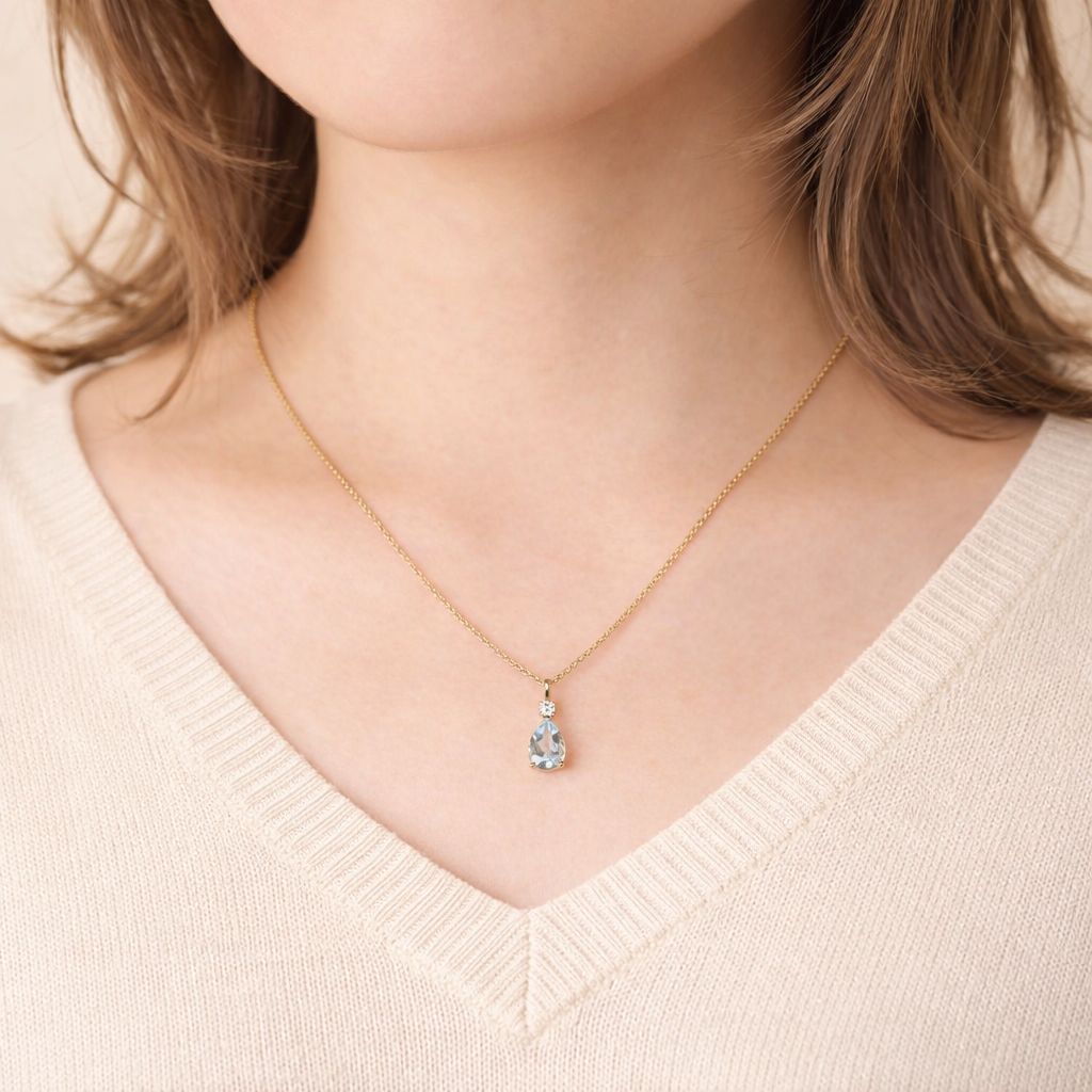 Unique Aquamarine Pendant Featuring A Pear Gemstone And Round Diamond.
