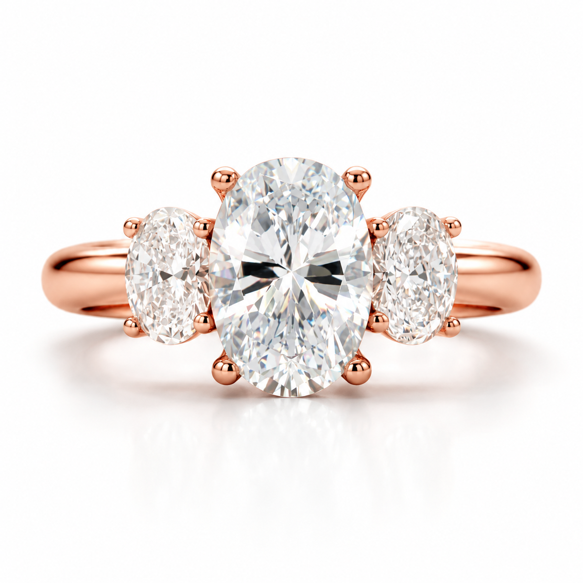 18K rose gold three stone engagement ring featuring a large oval center diamond with matching oval side diamonds, polished rose gold band, elegant prong setting, brilliant gemstone sparkle, and luxurious fine jewelry design on a clean white background.