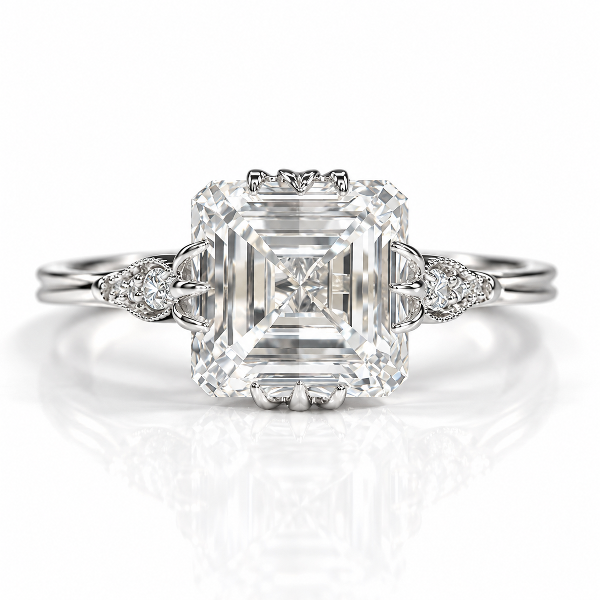 Silver Asscher-cut engagement ring with vintage leaf-inspired side details and accent diamonds.