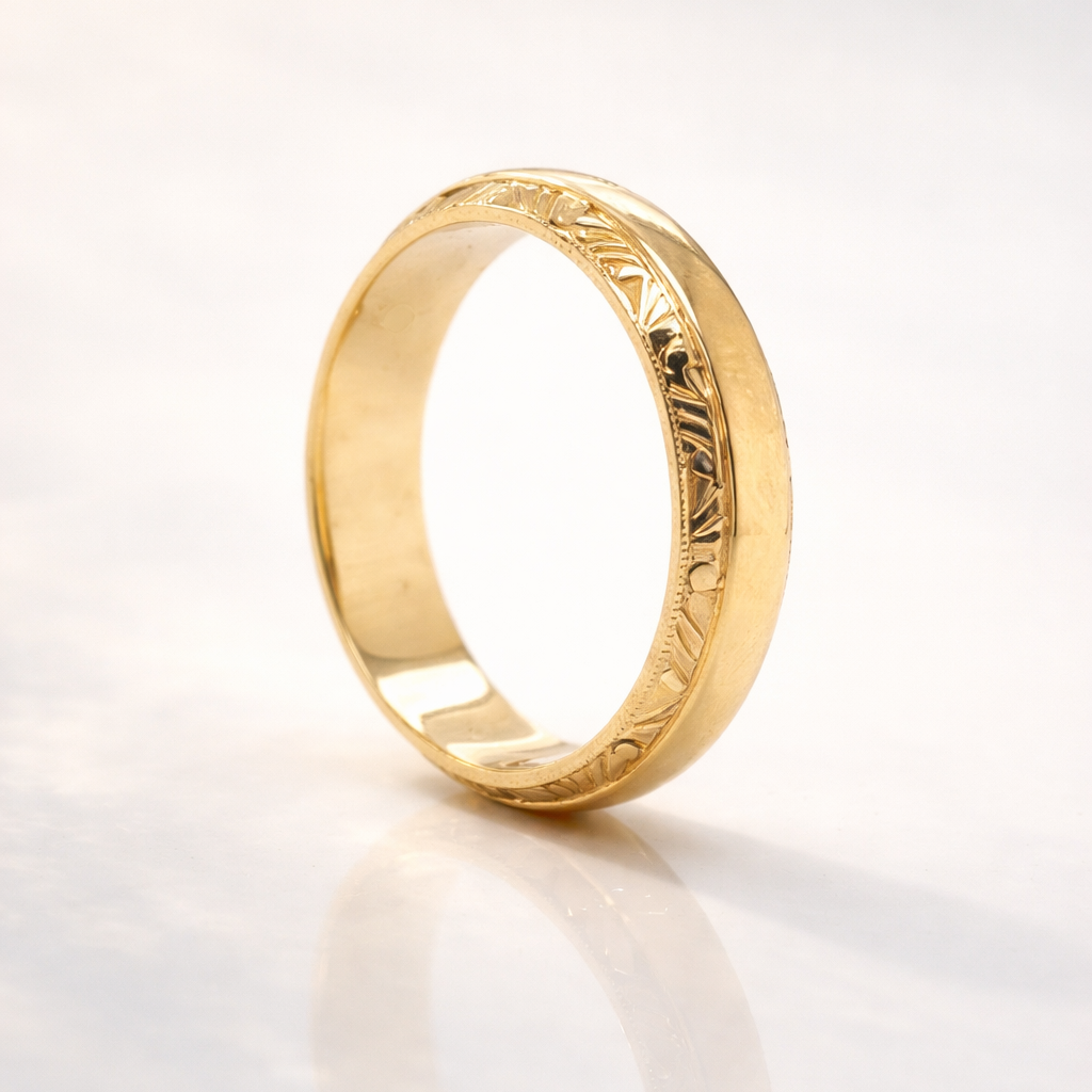 Gold ring with intricate design on a light gray background