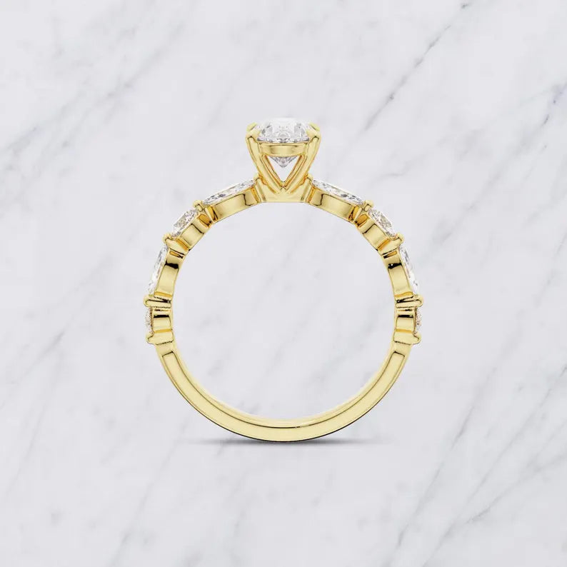 Elegant Oval Engagement Ring With Marquise Side Stones And Gold Band
